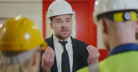 Close up back view of angry factory manager arguing with two engineers Stock Footage 112058967
