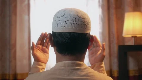 Close up back view of Asian muslim man praying with raising his hand Stock Footage 323164162