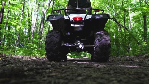 Close up. Back view. The ATV rides on the road on the camera. Stock Footage 139884402