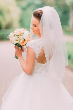 The close-up back view of the bride with bare shoulders holding the wedding Foto stock