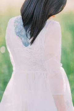 The close-up back view of the bride in the white dress with the open shoulders Stock Photos