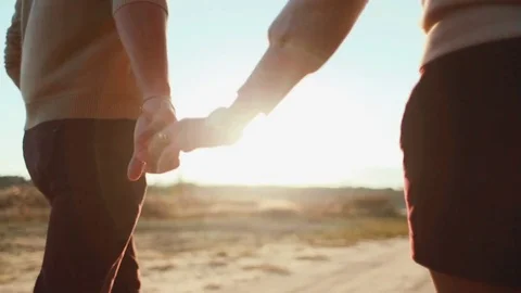 Close up back view of a couple in a romantic relationships, holding their hands Video stock 71761637