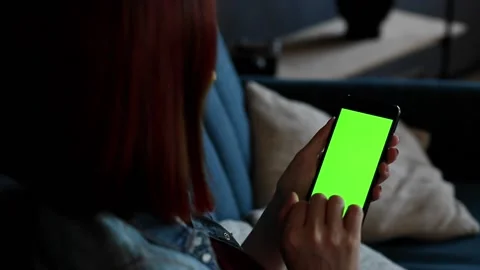 Close up back view of female hands holding smartphone with green screen for copy Stock Footage 162466828