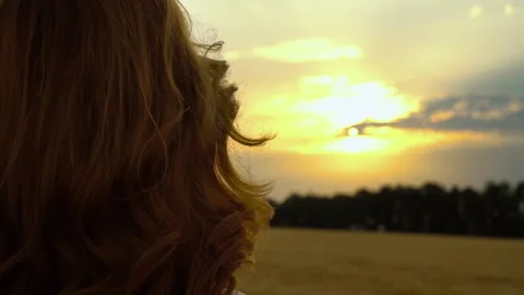 Close up back view of ginger girl enjoying beautiful summer sunset Stock Footage 344036064
