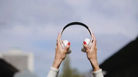 Close back view of a girl wearing headphones smiling and dancing Stock Footage