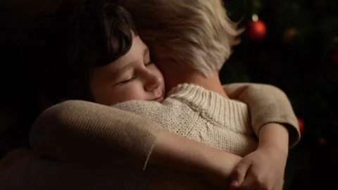 Close-up back view of happy little child son hugging loving young mother near Video stock 165579296