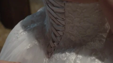 Close-up Back View of Lacing and Tying Satin Ribbon Corset on Bride's Wedding Stock Footage 342477795
