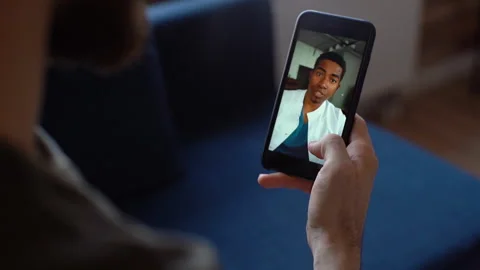 Close-up back view of male chatting via video call with African American doctor Video stock 150052566