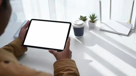 Close up back view of man young man using digital tablet and sitting in front Stock Photos