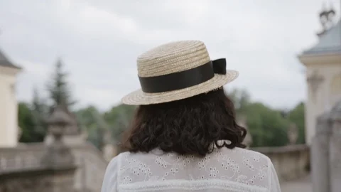 Close up back view of pretty smiling mulatto woman walking in old-fashioned Video stock 94875170