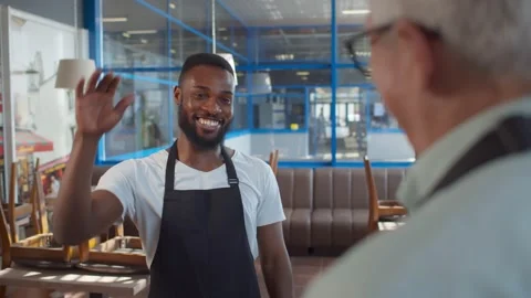 Close up back view of senior cafeteria owner and young afro-american waiter Stock Footage 135224804