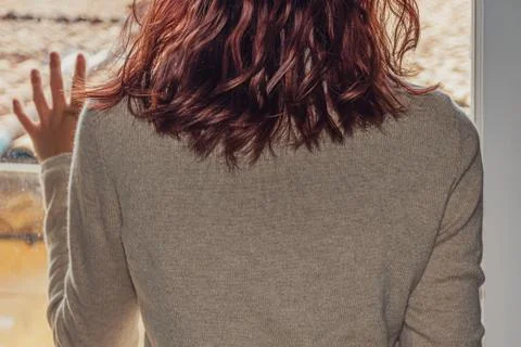 A close-up back view shot of an unrecognizable young Caucasian redheaded woma Stock Photos