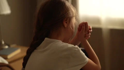 Close-up back view of upset little girl crying sitting alone on bed on Stock Footage 150895119