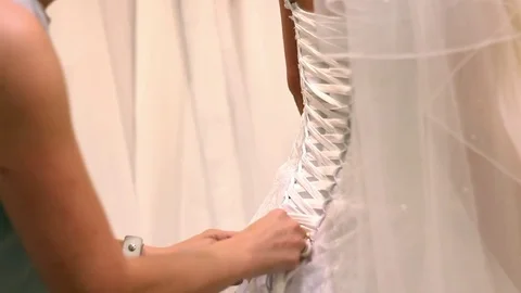 Close up of back of young bride getting ready for wedding ceremony. Mother Stock Footage 80991291