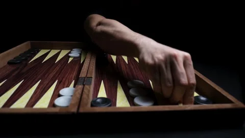 Close-up of Backgammon Board, Hand Waiting for Opponent to Make a Move Stock Footage 330434853