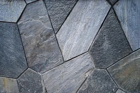 Close up background and surface of wall and floor tiles made of big granite rock Stock Photos