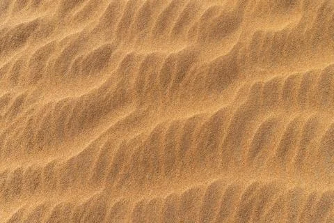 Close-up  background brown sand wave with rippled dunes. Stock Photos