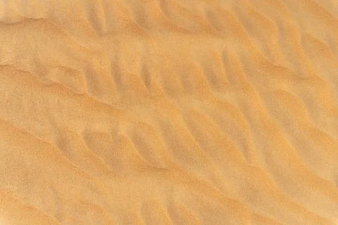 Close-up  background brown sand wave with rippled dunes. Stock Photos
