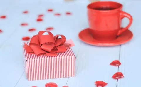 Close-up background image of red Cup and gift box on light background. Stock Photos