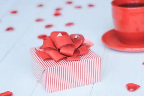 Close-up background image of red Cup and gift box on light background. Stock Photos