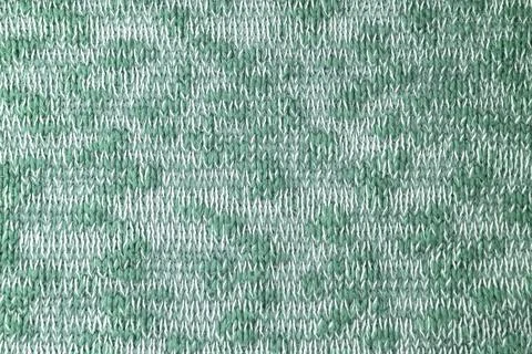 Close up background of knitted wool fabric made of viscose yarn. Mix of green Stock Photos