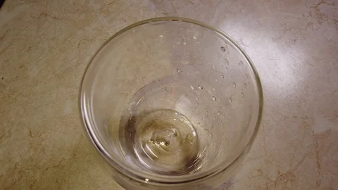 Close up background of pouring beer with bubbles and foam in glass, low angle si Stock Footage 104928267