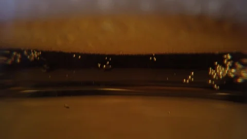 Close up background of pouring beer with bubbles and foam in glass, low angle si 動画素材 104931741