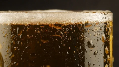 Close up background of pouring beer with bubbles and foam in glass Stock Footage 105785721