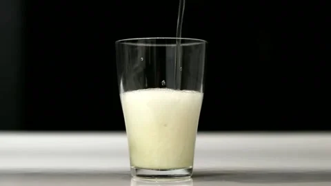 Close up background of pouring beer with bubbles and foam in glass, low angle Stock Footage 161982037