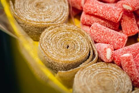 Close-up, background with rolled gummies coated with sugar. Stock Photos