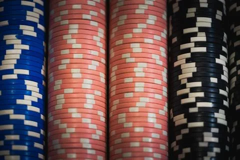 Close up background of stacked casino chips columns on gaming table. Stock Photos