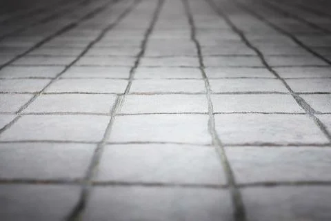 Close up background texture gray street pavement made of brick square stone Stock Photos