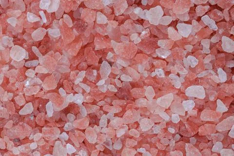 Close up background texture of small fine ground crystals pink Himalayan salt Stock Photos