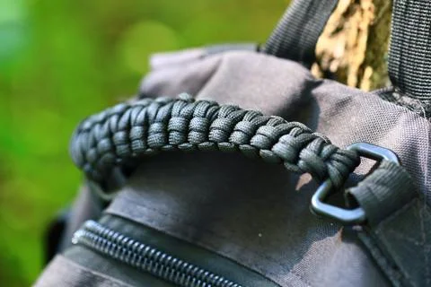 Close-up of a backpack featuring a paracord strap, suitable for outdoor and Stock Photos