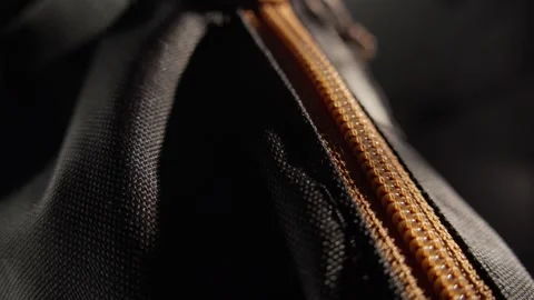 Close-up of a Backpack Zipper with Orange Pull Tab Stock Footage 296159498