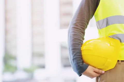 Close up backside view of engineering male construction worker stand holdin.. Stock Photos
