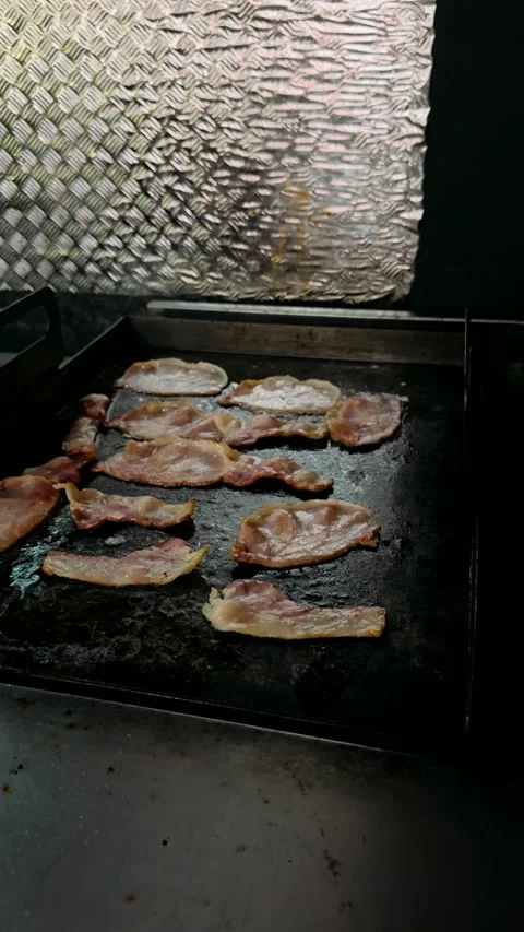 Close-up of bacon frying on a barbecue Stock Footage 325452819