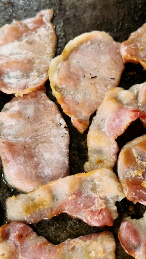 Close-up of bacon frying on a barbecue Stock Footage 325452921