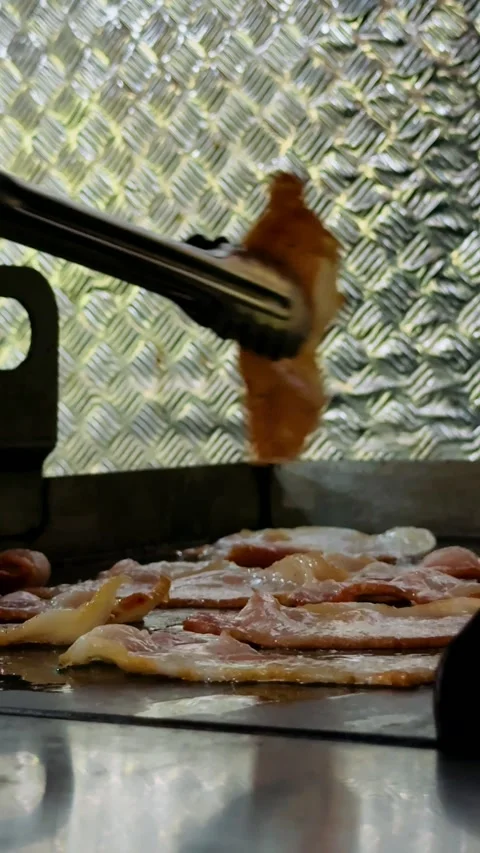 Close-up of bacon frying on a barbecue Stock Footage 325452944
