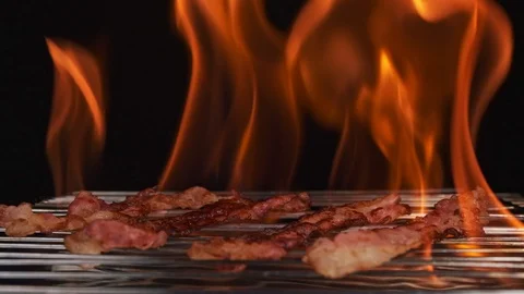 Close-up of bacon frying on the fire. Black background Vidéo 126588446