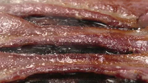 Close up of bacon frying Stock Footage 10910129