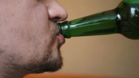 Close up of badly shaved male drinking alcohol with pleasure licking his lips Stock Footage 197079110