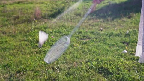 Close-up of a badminton racket hitting a shuttlecock against a background of Stock Footage 213329593