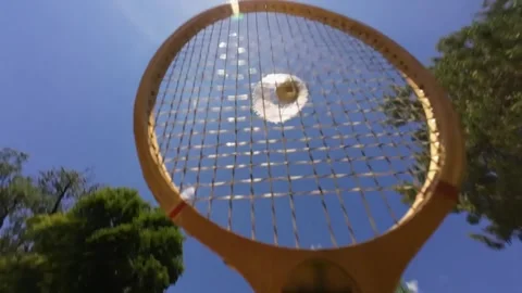 Close-up of badminton shuttlecock flying behind racket strings Stock Footage 336508192