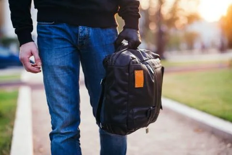 Close-up of bag being held by gloved hand of robber Stock Photos