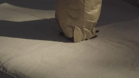 Close up on bag pouring coffee on rustic tablecloth Stock Footage 164092272