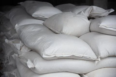 Close-up of bags of sugar in the warehouse of the processing plant. Stock Photos