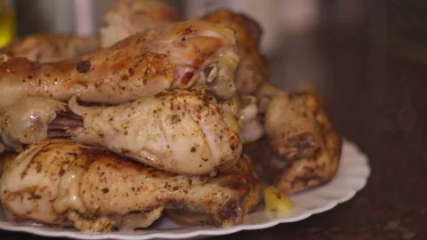 Close-up of Baked Chicken Drumsticks on White Plate Stock-Footage 335229698