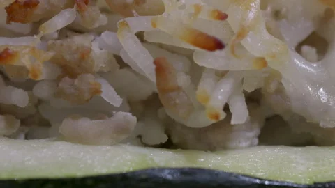 Close-up of baked stuffed zucchini with melted cheese Video stock 312369968