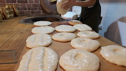 Close-up of a baker cook kneading dough for tortillas to be cooked in a tandoor. Stock Footage 320877560